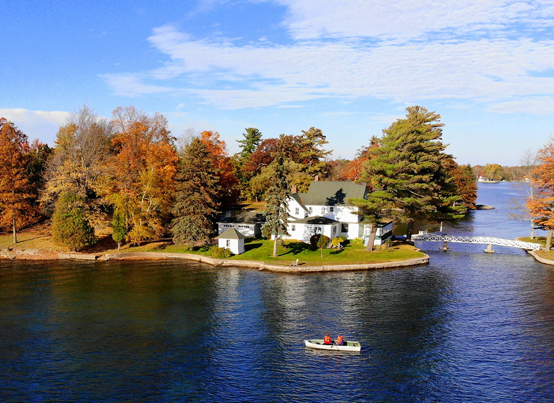 Personal Insurance - Aerial View of Residential Area and Waterfront Homes Surrounded by Colorful Fall Foliage Near Wellesley Island, New York