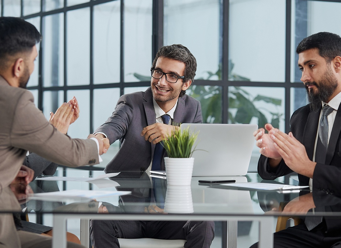 The Huntington Agency - Business People Shaking Hands After a Meeting